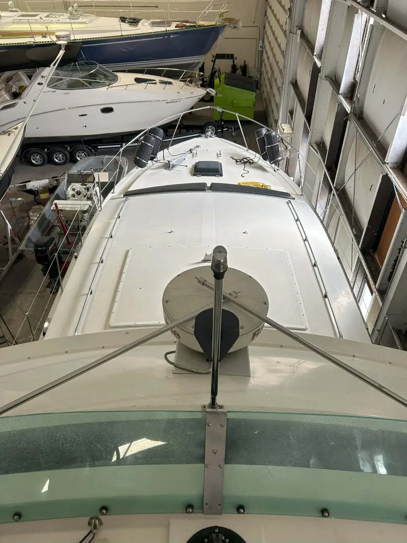 Slide: The Image of 1977 Bertram 42 Motor Yacht in storage, view from above, surrounded by other boats. - 12