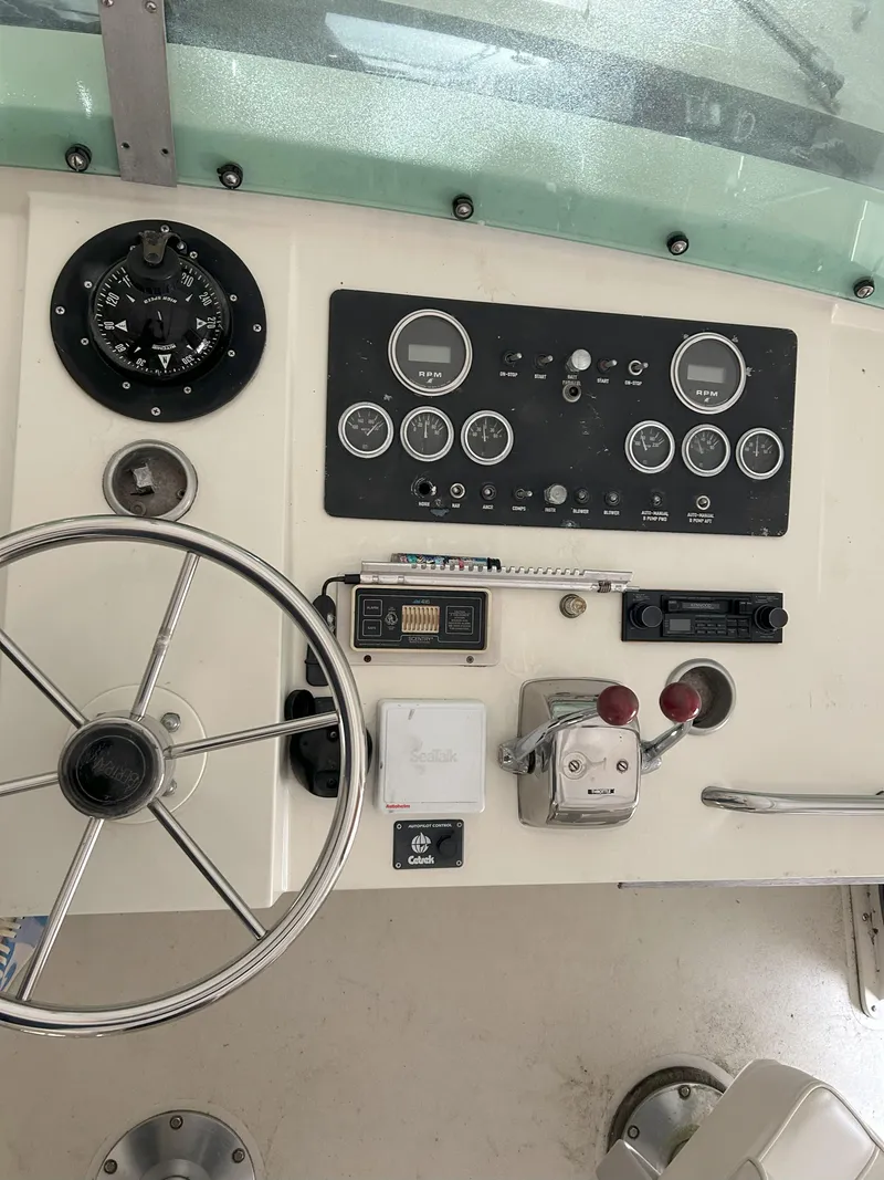 Slide: The Image of 1977 Bertram 42 Motor Yacht helm with steering wheel and instrument panel. - 13