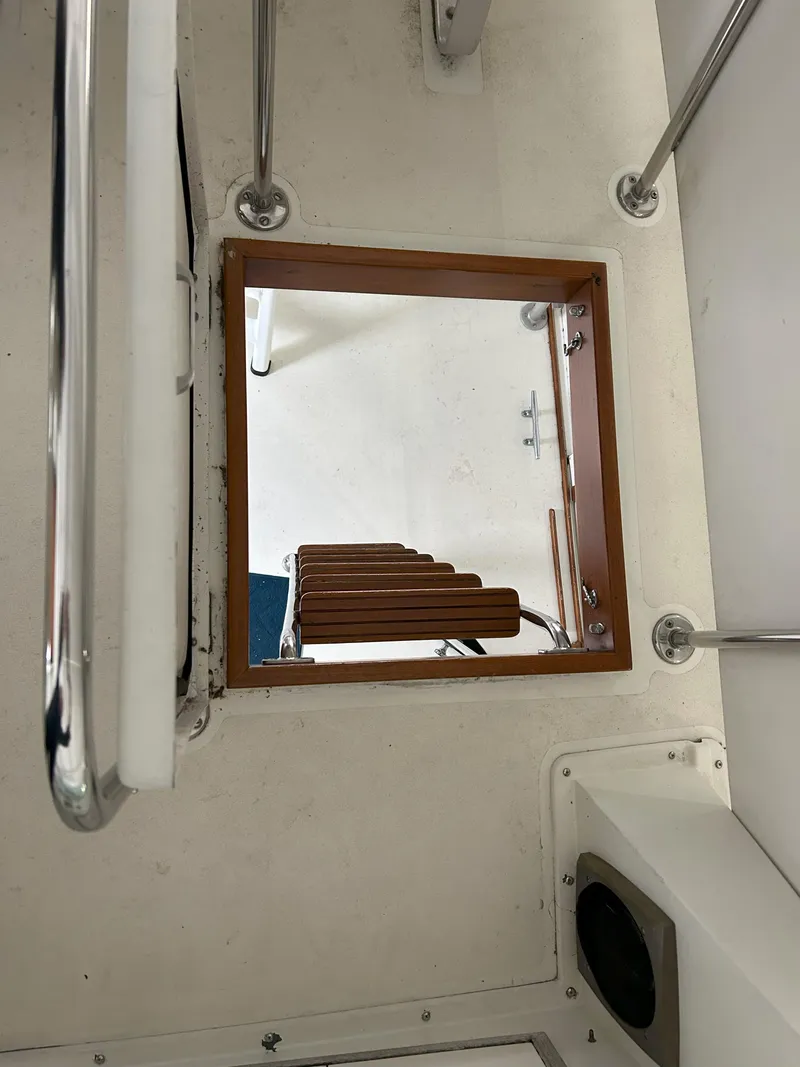 Slide: The Image of 1977 Bertram 42 Motor Yacht interior hatch with wooden steps and metal railings. - 15