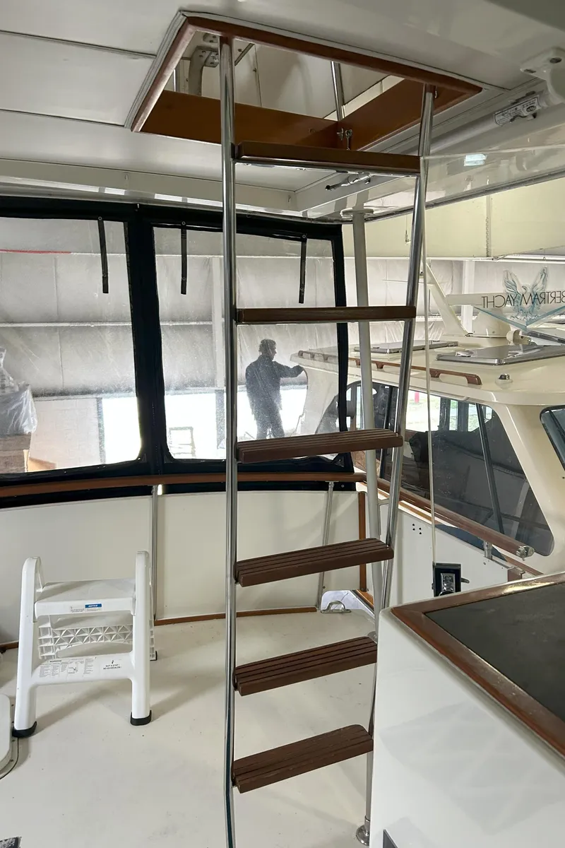 Slide: The Image of 1977 Bertram 42 Motor Yacht interior with ladder and window view. - 16