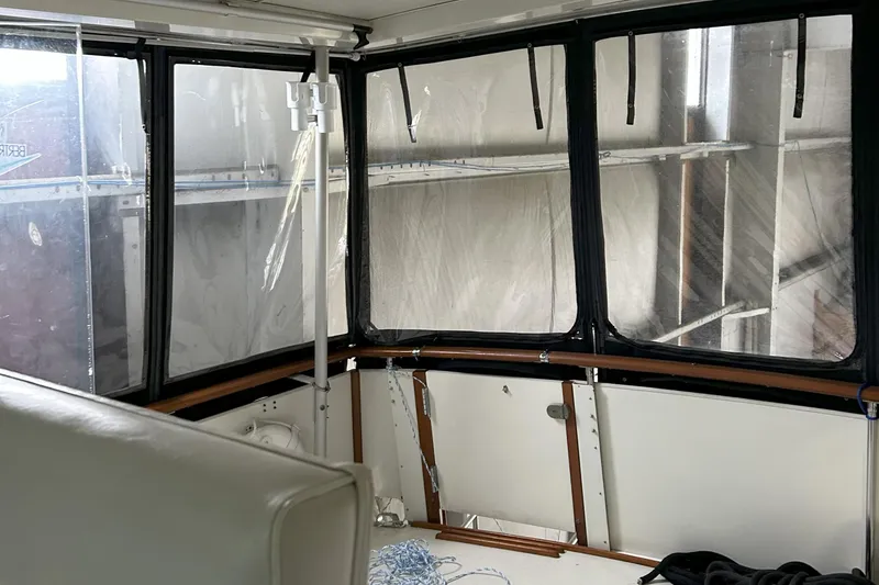 Slide: The Image of 1977 Bertram 42 Motor Yacht interior with large windows and seating area. - 17