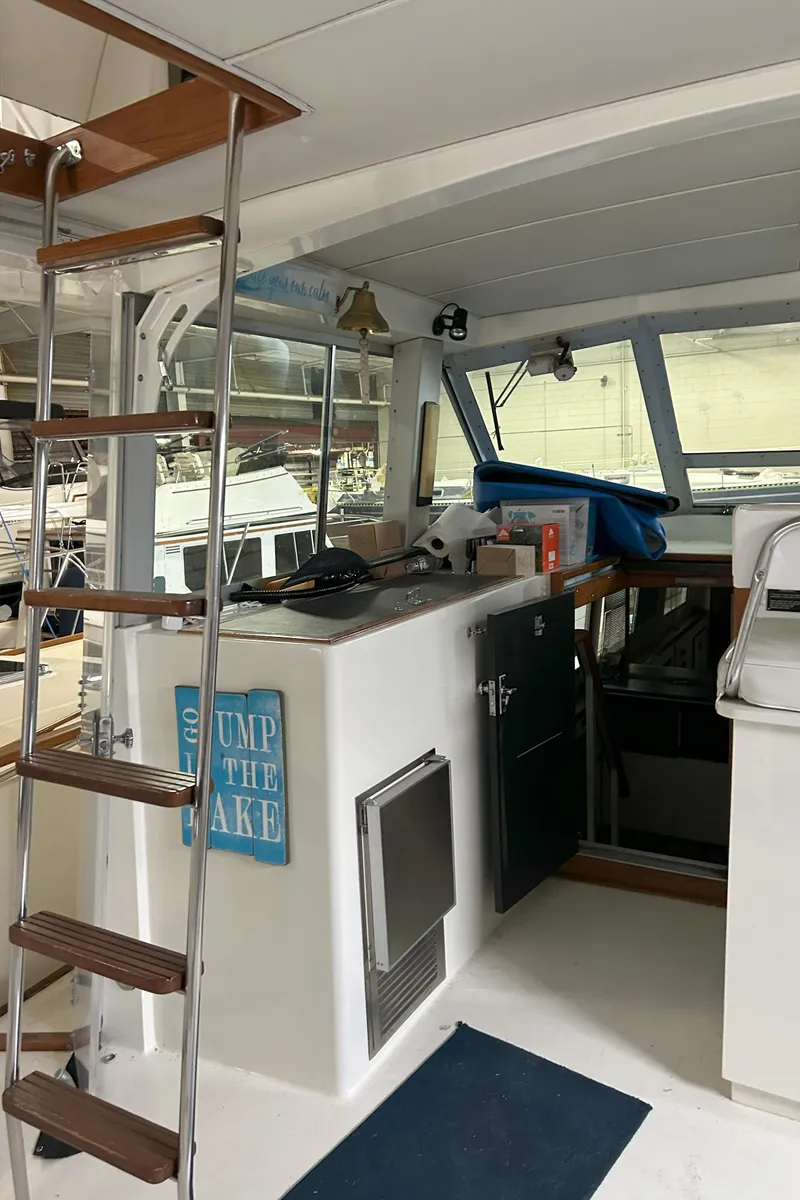 Slide: The Image of 1977 Bertram 42 Motor Yacht interior with ladder and helm station. - 18