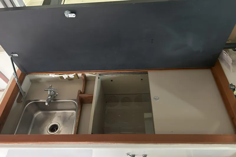 Slide: The Image of 1977 Bertram 42 Motor Yacht kitchen sink and counter with storage space. - 23