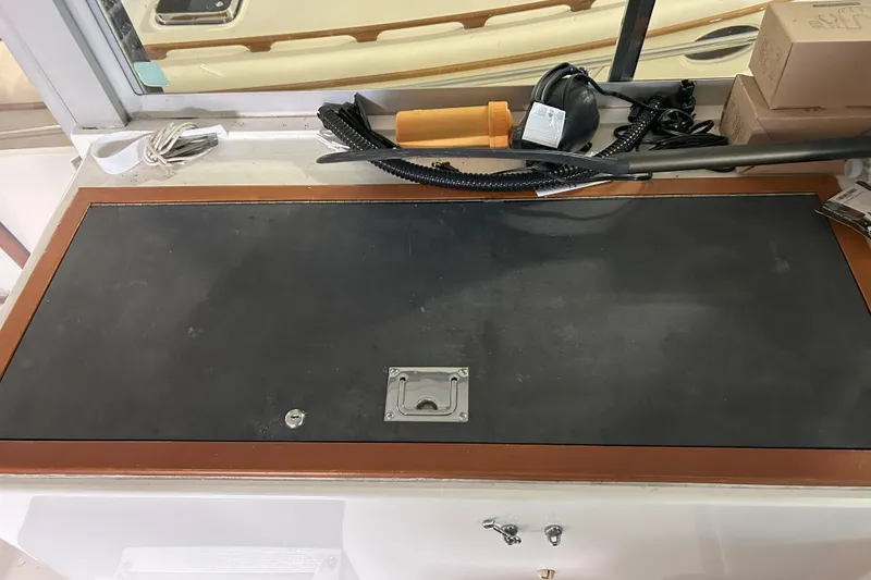 Slide: The Image of 1977 Bertram 42 Motor Yacht interior detail with storage compartment and equipment. - 24