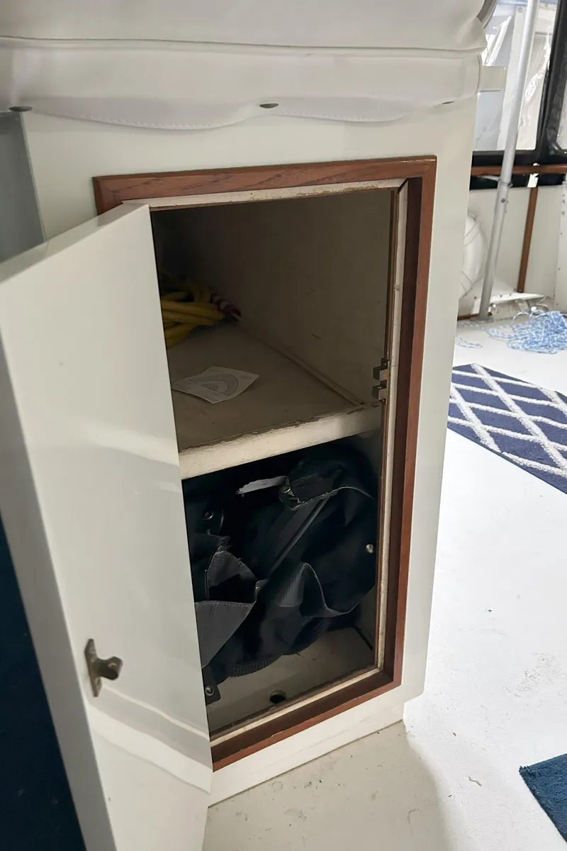 Slide: The Image of Open storage cabinet inside a 1977 Bertram 42 Motor Yacht, showing interior shelves. - 26
