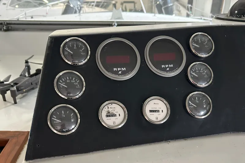 Slide: The Image of Dashboard of a 1977 Bertram 42 Motor Yacht with various gauges and RPM meters. - 28