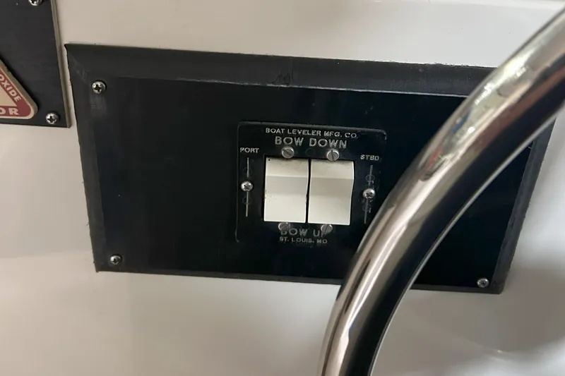 Slide: The Image of Control panel on a 1977 Bertram 42 Motor Yacht, featuring bow adjustment switches. - 34