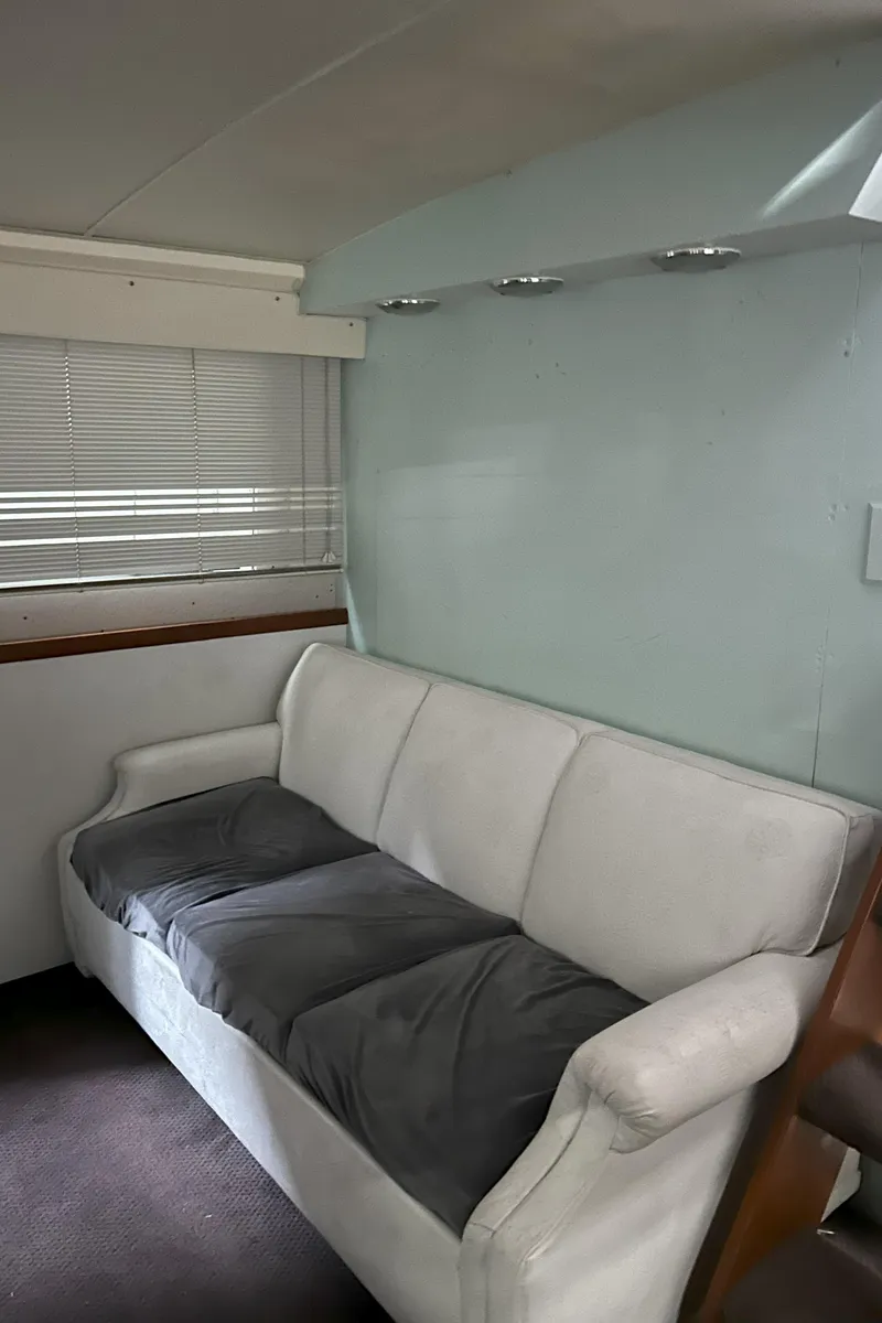 Slide: The Image of 1977 Bertram 42 Motor Yacht interior with white sofa and window blinds. - 36