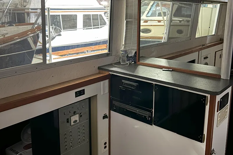 Slide: The Image of Interior of a 1977 Bertram 42 Motor Yacht with cabinetry and large windows. - 37