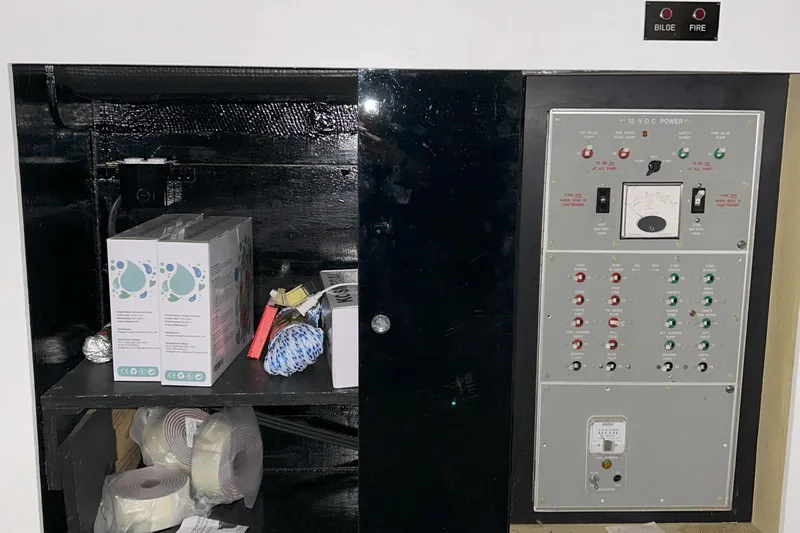 Slide: The Image of Electrical panel and storage on a 1977 Bertram 42 Motor Yacht. - 38