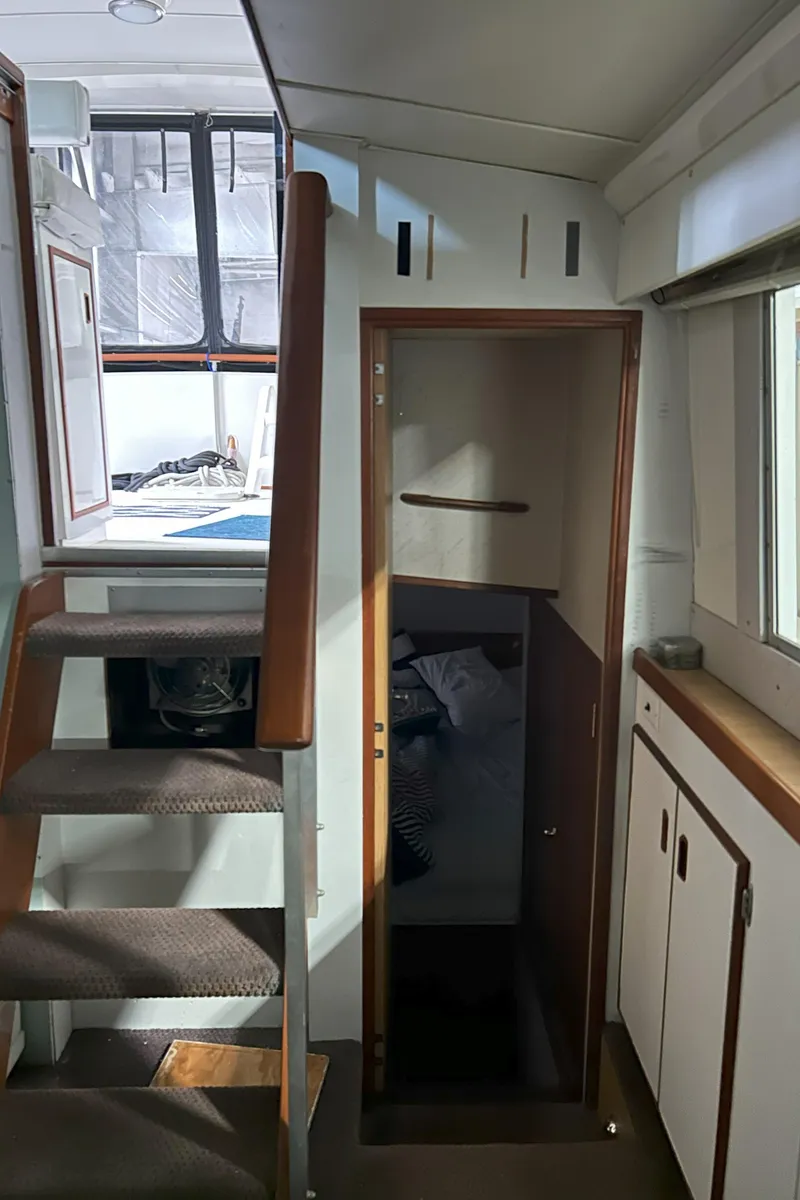 Slide: The Image of 1977 Bertram 42 Motor Yacht interior with stairs and cabin entrance. - 43