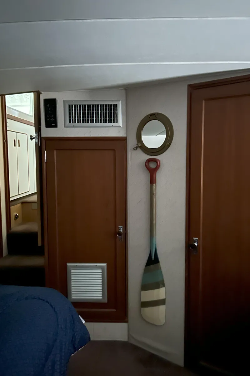 Slide: The Image of Interior of 1977 Bertram 42 Motor Yacht with wooden paneling and nautical decor. - 46