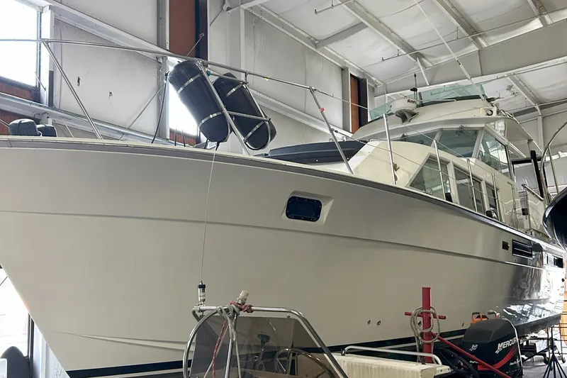 Slide: The Image of 1977 Bertram 42 Motor Yacht in a spacious indoor storage facility. - 6