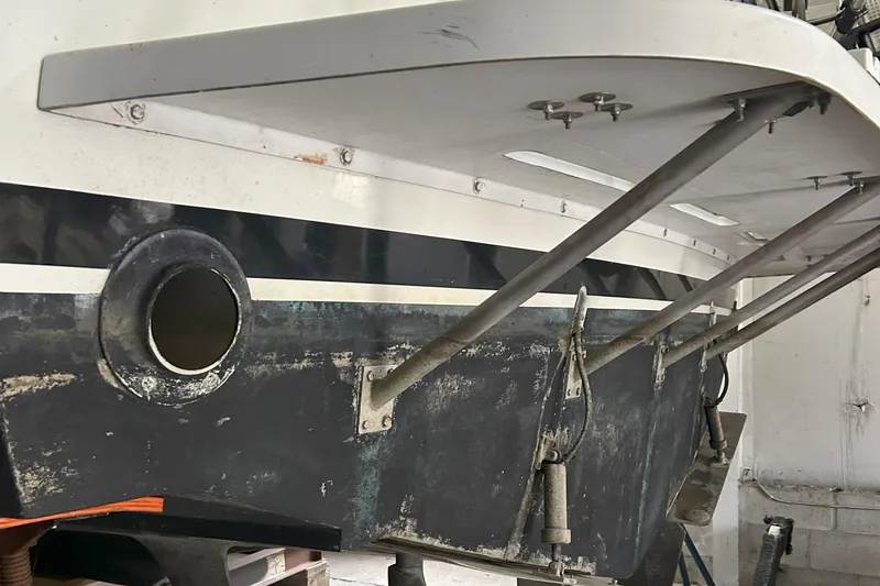 Slide: The Image of 1977 Bertram 42 Motor Yacht stern view, showcasing hull details and support structures. - 8