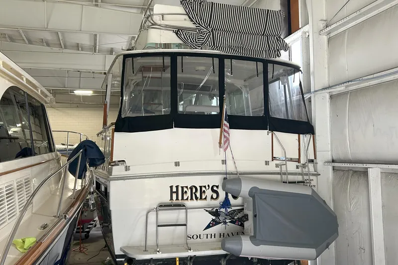Slide: The Image of 1977 Bertram 42 Motor Yacht in storage, rear view with covered deck, South Haven. - 9