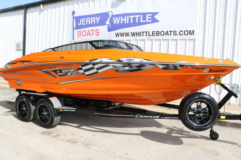 Slide: The Image of 2022 Crownline 220 SS LPX boat in vibrant orange on a trailer at Jerry Whittle Boats. - 10