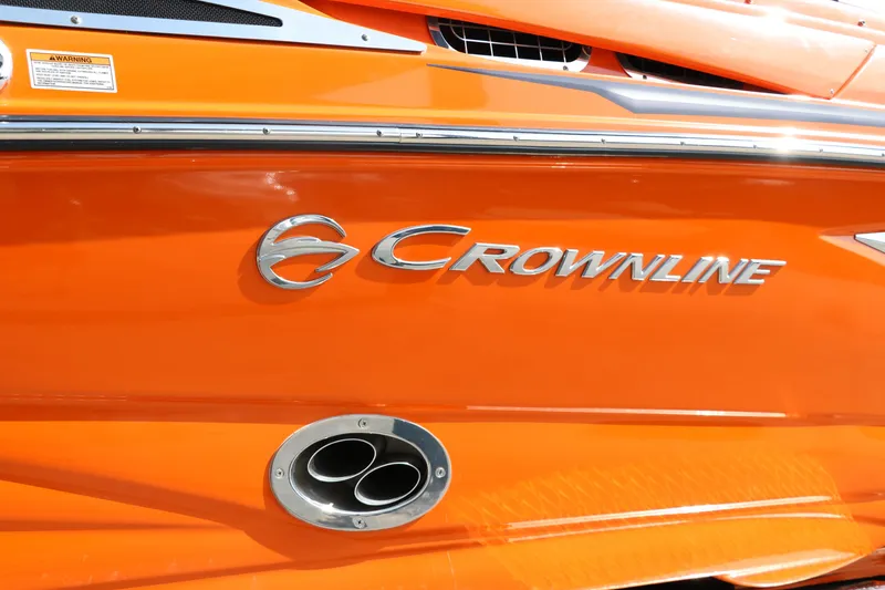 Slide: The Image of Orange 2022 Crownline 220 SS LPX boat with logo and exhaust detail. - 12