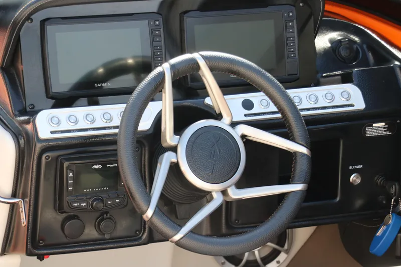 Slide: The Image of Steering wheel and dashboard of 2022 Crownline 220 SS LPX boat with dual displays. - 16