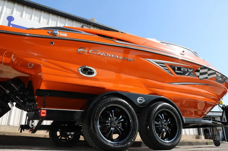 Slide: The Image of 2022 Crownline 220 SS LPX boat, vibrant orange, on trailer, side view. - 2