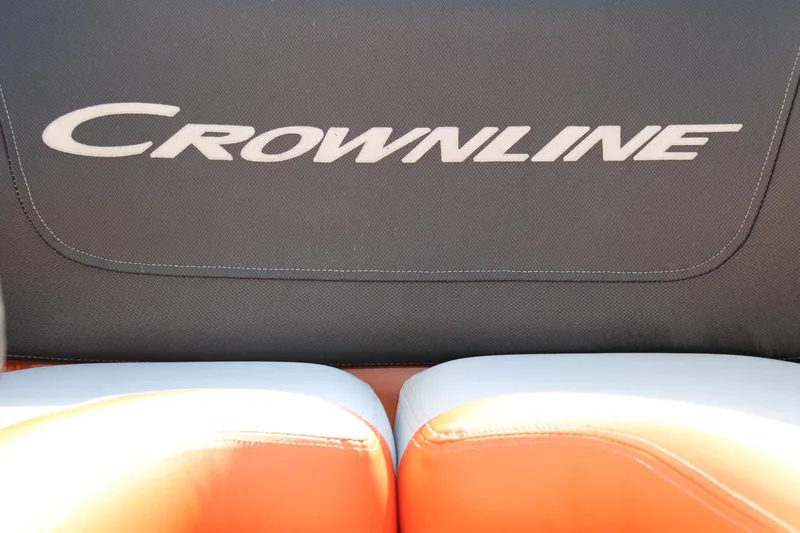 Slide: The Image of Crownline 220 SS LPX 2022 boat seat with logo, featuring orange and white upholstery. - 24