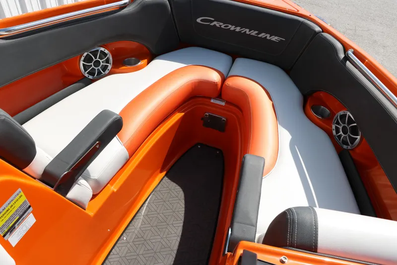 Slide: The Image of 2022 Crownline 220 SS LPX boat interior with orange and white seating, featuring speakers. - 25