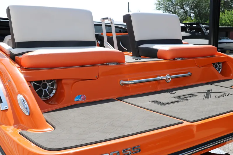 Slide: The Image of 2022 Crownline 220 SS LPX boat with orange and black seating, rear view. - 28
