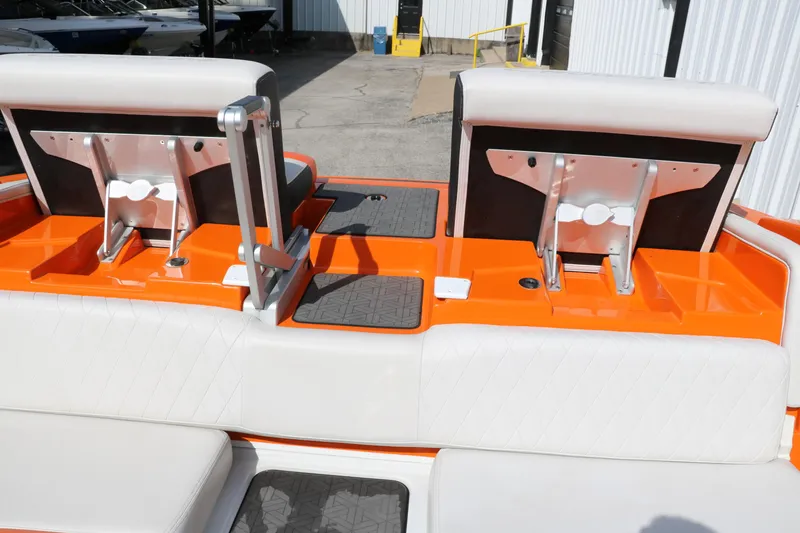 Slide: The Image of 2022 Crownline 220 SS LPX boat interior with orange accents and adjustable seating. - 31