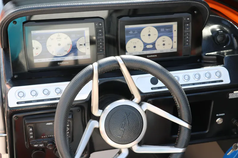 Slide: The Image of Steering wheel and dashboard of 2022 Crownline 220 SS LPX boat with dual Garmin displays. - 32