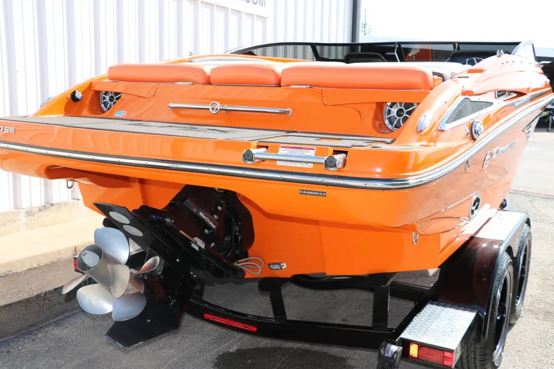 Slide: The Image of 2022 Crownline 220 SS LPX boat in vibrant orange on a trailer. - 4