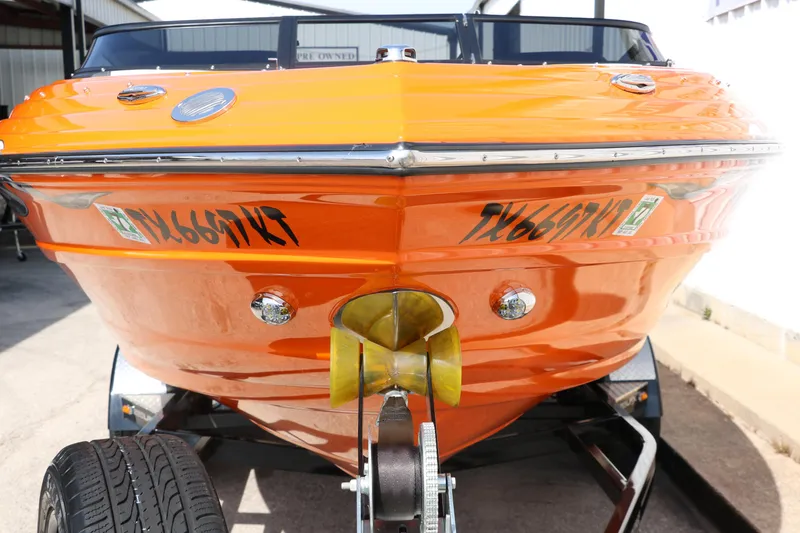 Slide: The Image of 2022 Crownline 220 SS LPX boat in vibrant orange, front view on trailer. - 8