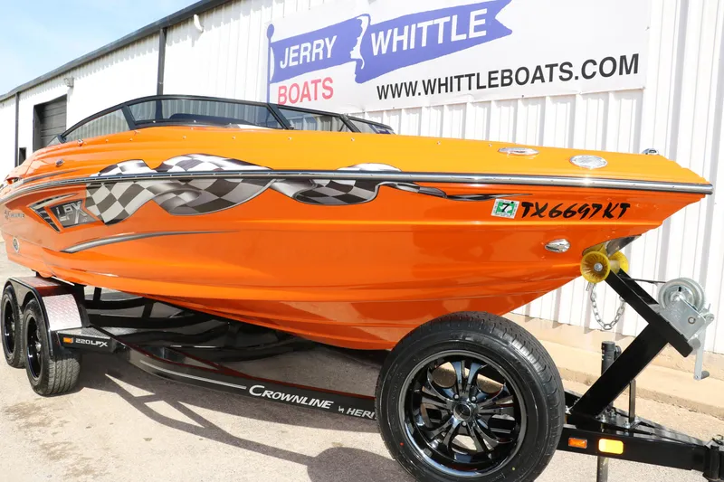 Slide: The Image of 2022 Crownline 220 SS LPX boat in vibrant orange, displayed at Jerry Whittle Boats. - 9