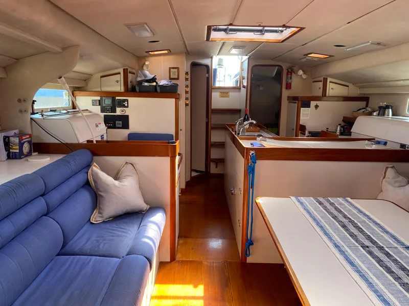 Slide: The Image of Interior of a 1995 Sundeer 56 yacht with blue seating and wooden accents. - 20