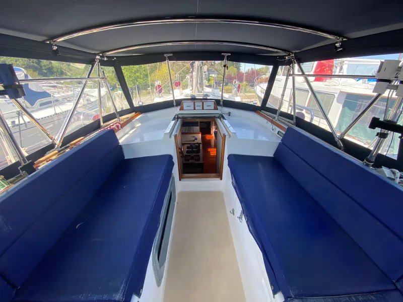 Slide: The Image of Interior view of a 1995 Sundeer 56 yacht with blue seating and navigation area. - 26