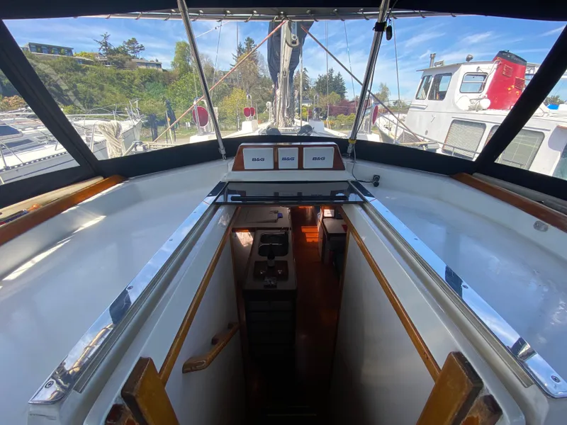Slide: The Image of Cockpit view of 1995 Sundeer 56 sailboat, showing cabin entrance and navigation instruments. - 27