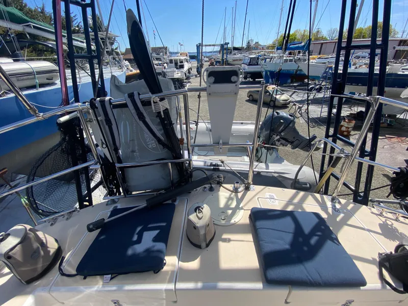 Slide: The Image of Sundeer 56 sailboat deck, 1995 model, with seating and equipment, docked in a marina. - 30