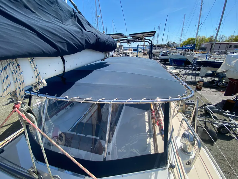 Slide: The Image of Sundeer 56 sailboat, 1995 model, docked with blue canopy and rigging, in a marina setting. - 36
