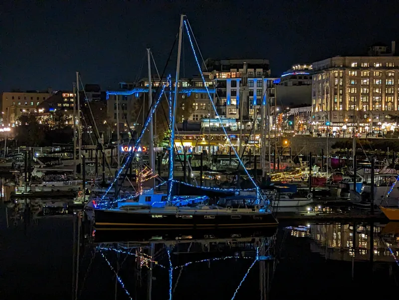 Slide: The Image of Sundeer 56 sailboat illuminated with blue lights at night in a vibrant marina, 1995 model. - 39