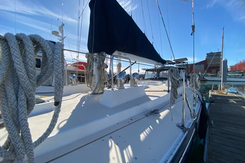 Slide: The Image of Sundeer 56 sailboat from 1995 docked at a marina, featuring ropes and sails. - 43