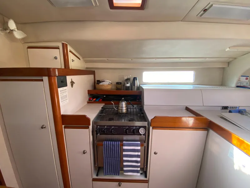 Slide: The Image of Interior of a 1995 Sundeer 56 yacht kitchen with stove and cabinets. - 5
