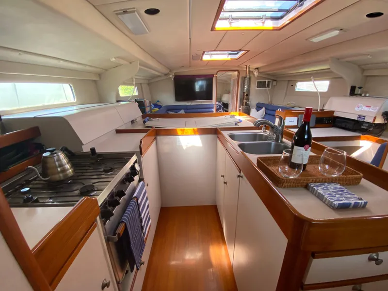 Slide: The Image of Interior of 1995 Sundeer 56 yacht kitchen with stove, sink, and wine setup. - 6