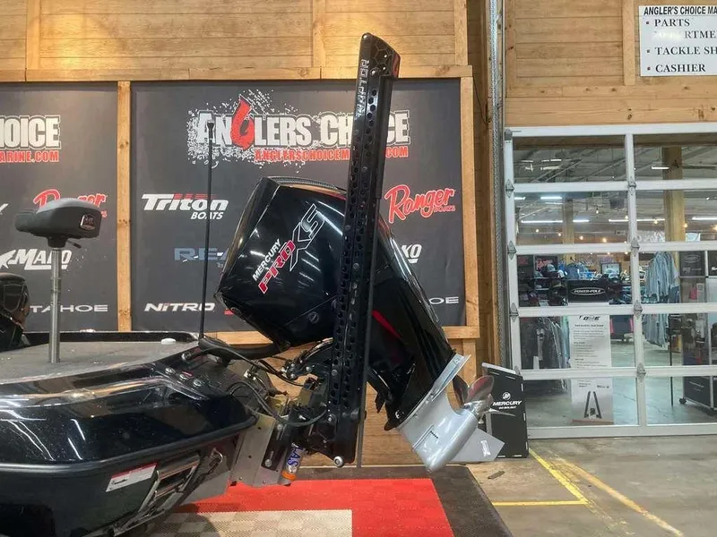 Slide: The Image of 2024 Ranger Z520R boat with powerful outboard motor displayed indoors. - 3