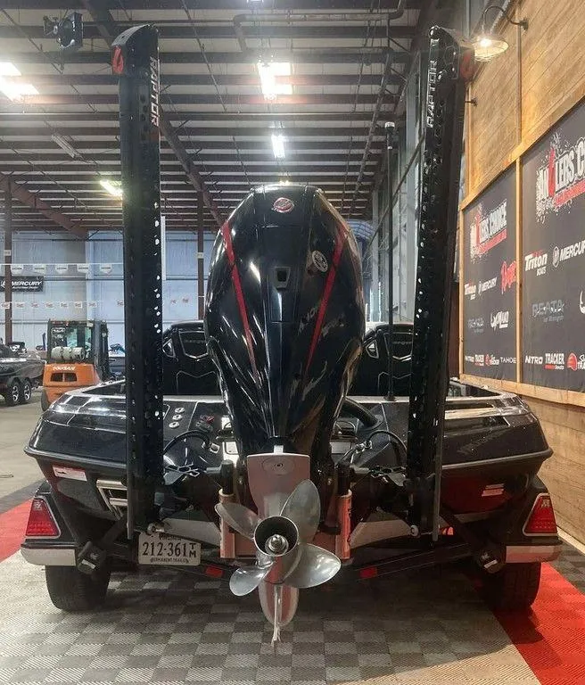 Slide: The Image of 2024 Ranger Z520R boat in showroom, rear view with motor and dual power poles. - 4
