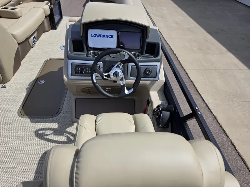 Slide: The Image of 2025 Regency 230 DL3 boat interior with steering wheel and Lowrance navigation system. - 6