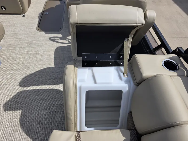 Slide: The Image of 2025 Regency 230 DL3 boat interior with beige seating and built-in storage compartment. - 8