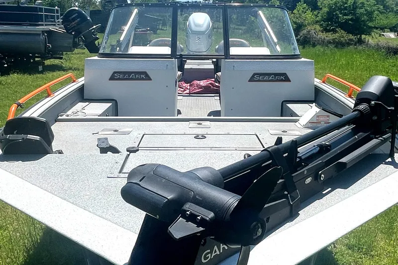 Slide: The Image of 2022 SeaArk ProCat 240 boat with open deck and fishing equipment. - 2