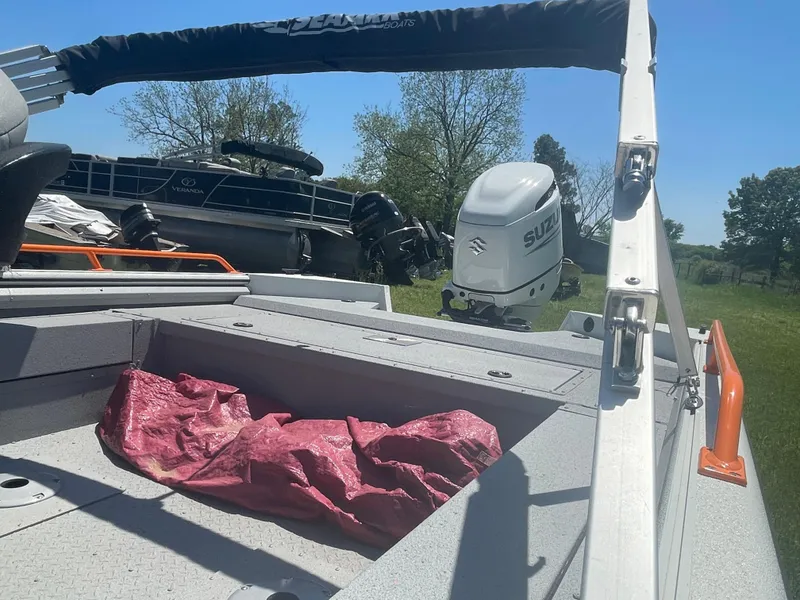 Slide: The Image of 2022 SeaArk ProCat 240 boat with Suzuki outboard motor, parked on grass. - 5