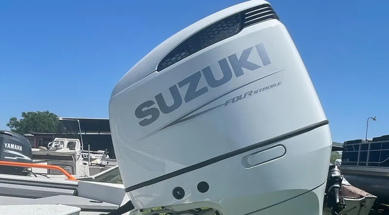 Slide: The Image of Suzuki four-stroke outboard motor on 2022 SeaArk ProCat 240 boat, docked under clear blue sky. - 6