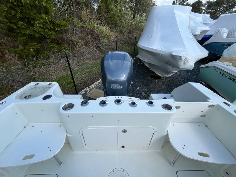 Slide: The Image of 2008 Sailfish 2360 WAC boat with Yamaha 250 engine, docked outdoors. - 14