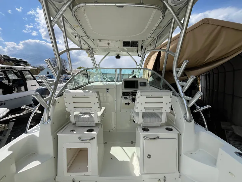 Slide: The Image of 2008 Sailfish 2360 WAC boat interior with dual seats and fishing rod holders. - 6