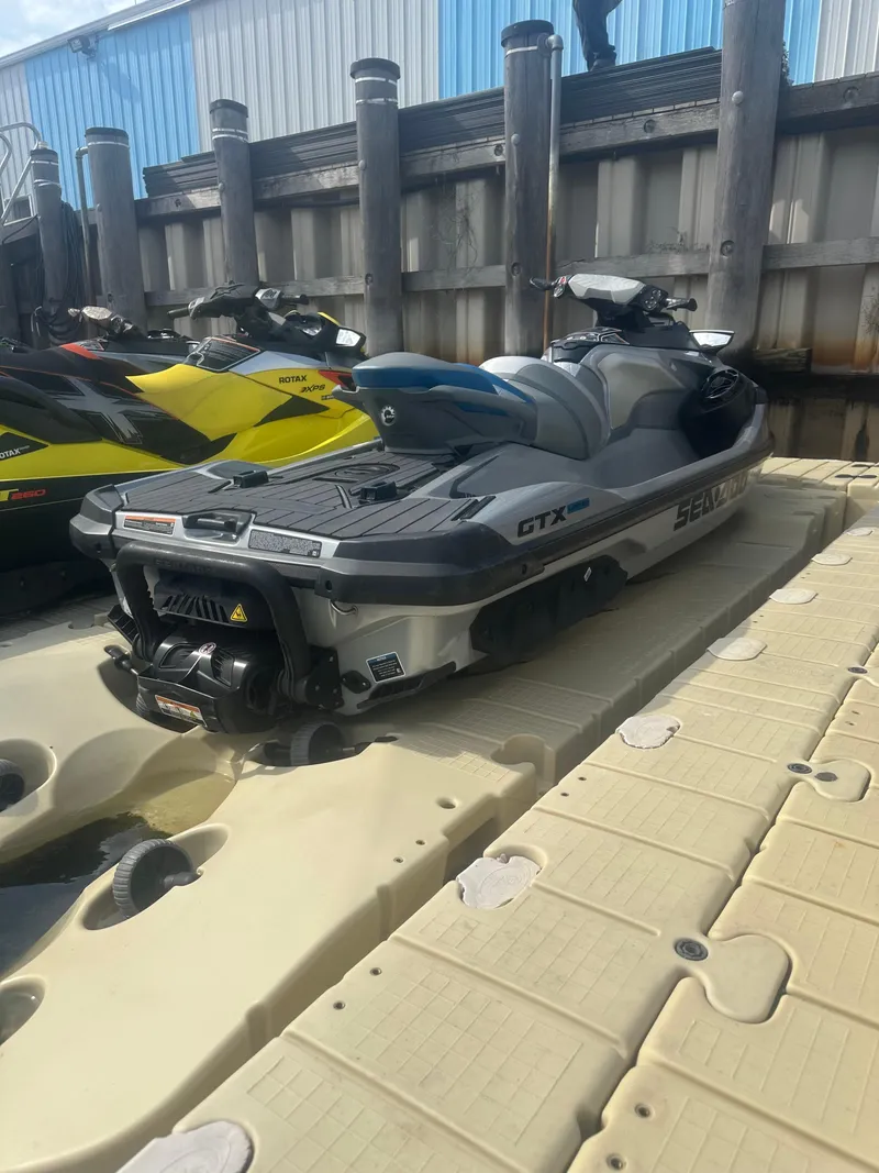Slide: The Image of 2021 Sea-Doo GTX Limited 300 jet ski on dock, gray and black design. - 11